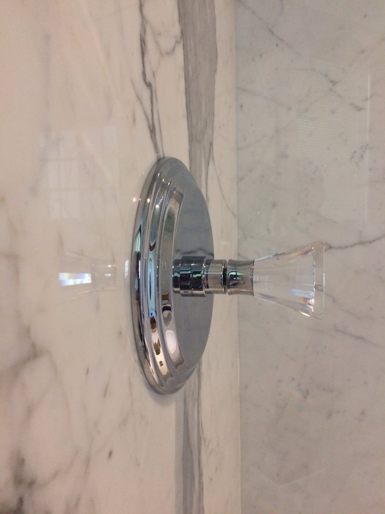 Marble shower wall with fixtures