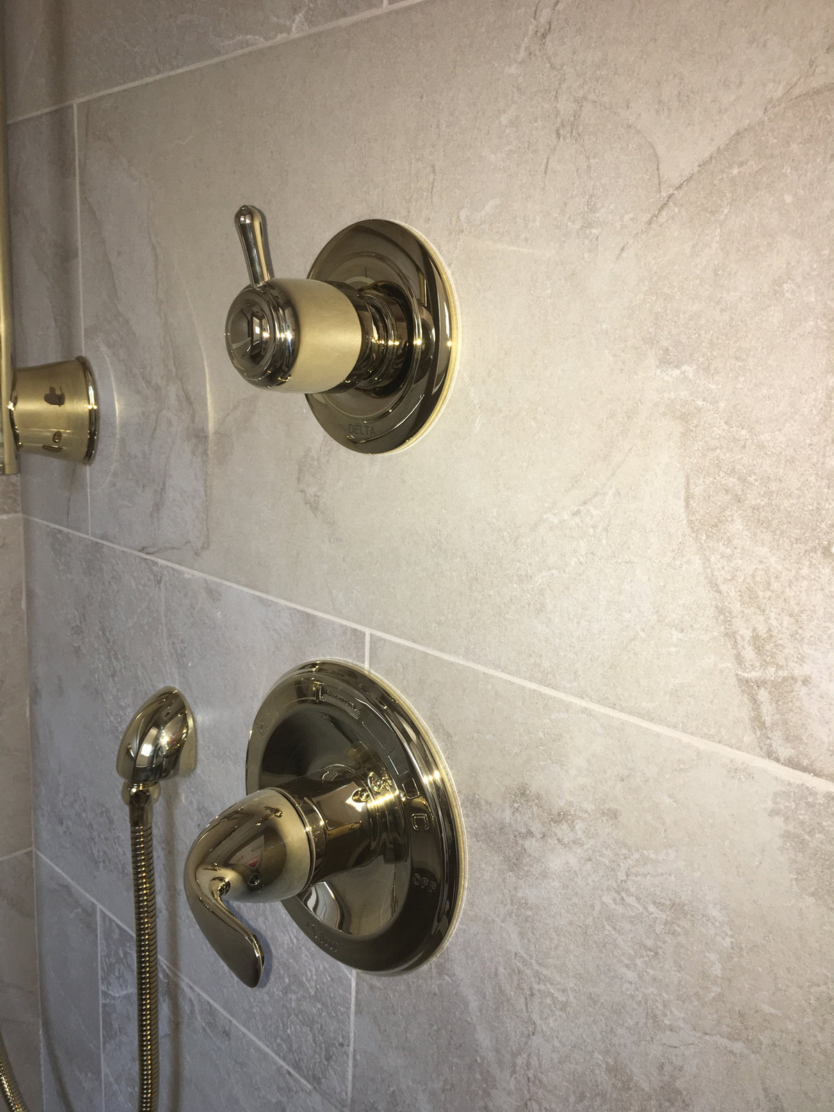 Brass shower valves on slate tile